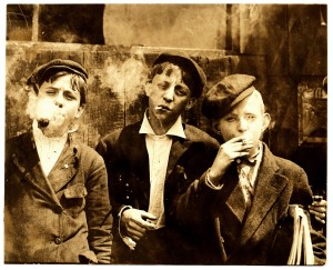 Lewis_Hine,_Newsies_smoking_at_Skeeter's_Branch,_St._Louis,_1910