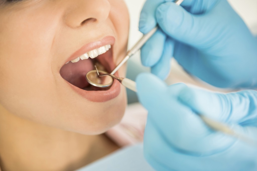 Dentist examining a patient's teeth in the dentist.