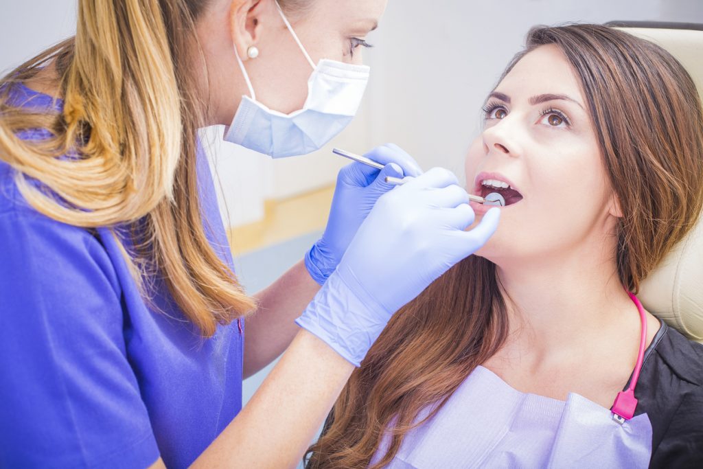 Patient having dental treatment at dentist's office.