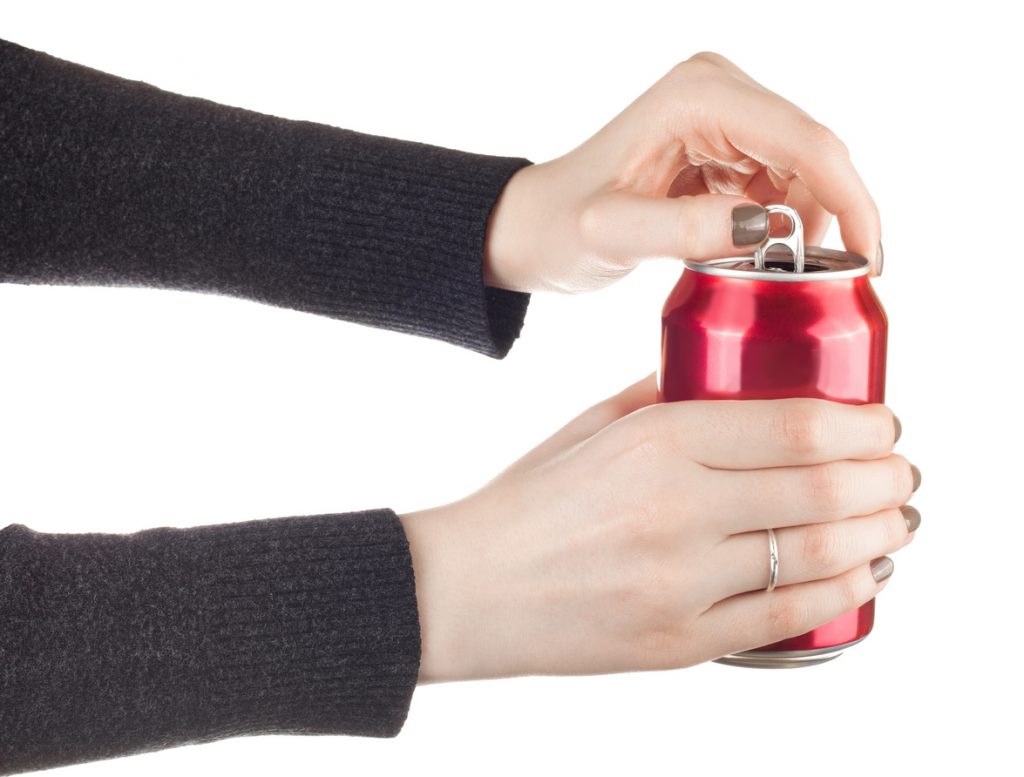 female hands opening a can of soda