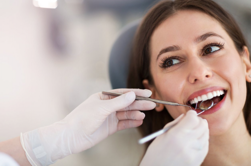 a happy young female dental patient