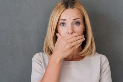 woman covering her mouth with her hand