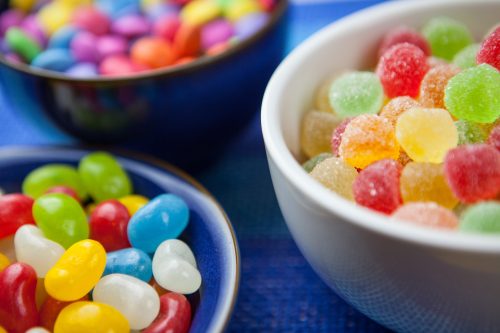 three bowls filled with jelly beans and jelly sweets