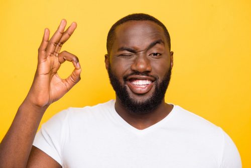 a man smiling and indicating with his hand that everything is okay